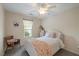 Comfortable bedroom with a ceiling fan, window, and charming decor at 108 Braxberry Way, Holly Springs, NC 27540