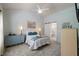 Comfortable bedroom with soft blue walls, plush carpeting, and a sliding barn door to ensuite bathroom at 108 Braxberry Way, Holly Springs, NC 27540