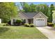 Charming single-story home featuring a well-maintained lawn, neat landscaping, and an attached one car garage at 108 Braxberry Way, Holly Springs, NC 27540