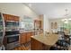 Well-lit kitchen with stainless steel appliances, a kitchen island, and eat-in kitchen area at 108 Braxberry Way, Holly Springs, NC 27540