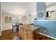 Open-concept eat-in kitchen features an island with wooden cabinets and a seating area for four at 108 Braxberry Way, Holly Springs, NC 27540