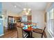Modern eat-in kitchen with stainless steel appliances, granite countertops, and a decorative kitchen sign at 108 Braxberry Way, Holly Springs, NC 27540