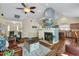 Open concept living room with fireplace, mounted TV, and views of the kitchen at 108 Braxberry Way, Holly Springs, NC 27540