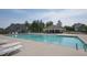 Community swimming pool with lounge chairs and clear blue water, ideal for relaxation and recreation at 108 Braxberry Way, Holly Springs, NC 27540