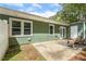 Relaxing patio in backyard next to the house, with outdoor seating and peaceful greenery at 12 Poppy Trl, Durham, NC 27713