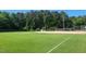 Well-maintained community baseball field with lush green grass and mature trees at 12 Poppy Trl, Durham, NC 27713