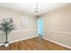 This dining room features a wood floor, a modern light fixture and neutral paint at 12 Poppy Trl, Durham, NC 27713