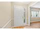 Bright foyer featuring wood floors, and a white front door with glass accent panel at 12 Poppy Trl, Durham, NC 27713