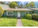 Charming one-story home with a well-manicured lawn and beautiful green exterior at 12 Poppy Trl, Durham, NC 27713