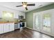 Well-equipped kitchen with white cabinets, stainless steel appliances, and a door to the patio at 12 Poppy Trl, Durham, NC 27713
