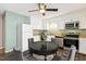 Charming kitchen with white cabinetry, stainless steel appliances, and cozy breakfast nook with a round table at 12 Poppy Trl, Durham, NC 27713