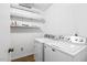 A clean and functional laundry room with modern Maytag washer and dryer, and shelving above at 12 Poppy Trl, Durham, NC 27713