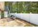 Inviting patio area with outdoor seating, white privacy fence, and view of the yard at 12 Poppy Trl, Durham, NC 27713