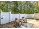 Cozy outdoor patio with chairs, small table, and privacy fence, creating an inviting space at 12 Poppy Trl, Durham, NC 27713