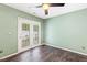 This empty room features dark flooring and a french door at 12 Poppy Trl, Durham, NC 27713