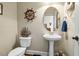 Charming powder room with pedestal sink and nautical decor at 12808 Edsel Dr, Raleigh, NC 27613