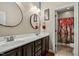 Bathroom with dual sinks and a red tree art on shower curtain at 12808 Edsel Dr, Raleigh, NC 27613