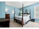 Bedroom with blue walls and a four poster bed at 12808 Edsel Dr, Raleigh, NC 27613