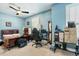 Bedroom with blue walls, ceiling fan, and natural light at 12808 Edsel Dr, Raleigh, NC 27613