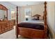 Traditional bedroom features a four-poster bed and wooden dresser at 12808 Edsel Dr, Raleigh, NC 27613