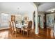 Elegant dining room with hardwood floors, chandelier, and doorway to the entryway at 12808 Edsel Dr, Raleigh, NC 27613