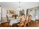 Cozy dining area features hardwood floors, traditional chandelier, and classic decor at 12808 Edsel Dr, Raleigh, NC 27613