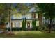 Charming two-story home featuring a combination of stone and siding, complemented by lush landscaping and mature trees at 12808 Edsel Dr, Raleigh, NC 27613