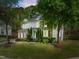 Attractive two-story home with a well-maintained lawn and garden, showcasing a mix of stone and siding accents at 12808 Edsel Dr, Raleigh, NC 27613