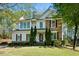 Beautiful two-story home with stone and siding, manicured lawn, and red shutters adding a pop of color at 12808 Edsel Dr, Raleigh, NC 27613