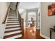 Foyer with hardwood floors, staircase, and dining room view at 12808 Edsel Dr, Raleigh, NC 27613