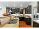 Updated kitchen with granite counters, stainless appliances, and dark wood cabinetry at 12808 Edsel Dr, Raleigh, NC 27613
