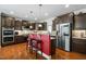 Spacious kitchen with dark cabinetry, a center island with seating, and stainless steel appliances at 12808 Edsel Dr, Raleigh, NC 27613