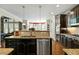 Well-appointed kitchen with granite countertops, stainless steel appliances, and dark wood cabinetry at 12808 Edsel Dr, Raleigh, NC 27613