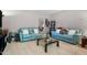 Sitting area with soft carpet and two comfortable light blue sofas at 12808 Edsel Dr, Raleigh, NC 27613