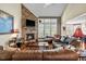 Comfortable living room with hardwood floors, a stone fireplace, and a large window at 12808 Edsel Dr, Raleigh, NC 27613