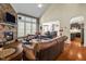 Open-concept living room with hardwood floors, stone fireplace, and seamless transition to the kitchen at 12808 Edsel Dr, Raleigh, NC 27613