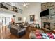 Inviting living room features hardwood floors, a stone fireplace, and a vaulted ceiling at 12808 Edsel Dr, Raleigh, NC 27613