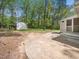Large backyard with mature trees, storage shed, and concrete patio at 1312 Rothes Rd, Cary, NC 27511