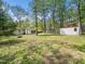 Spacious backyard featuring mature trees, shed, and an outdoor fire pit at 1312 Rothes Rd, Cary, NC 27511