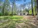 Expansive backyard with a patio, mature trees and a cozy screened porch at 1312 Rothes Rd, Cary, NC 27511