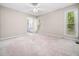 Spacious bedroom with ceiling fan and carpet flooring, with ensuite bathroom at 1312 Rothes Rd, Cary, NC 27511