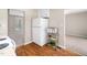 Spacious kitchen view featuring stainless steel microwave and refrigerator with wood-look floors at 1312 Rothes Rd, Cary, NC 27511
