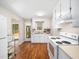 Bright kitchen features white appliances, ample cabinet space, and wood-look flooring at 1312 Rothes Rd, Cary, NC 27511