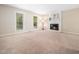 Bright living room with a cozy fireplace, neutral walls, and plush carpeting at 1312 Rothes Rd, Cary, NC 27511