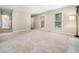 Comfortable living room with neutral tones, large windows, and an open layout at 1312 Rothes Rd, Cary, NC 27511