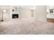 Bright living room with a cozy fireplace, neutral walls, and plush carpeting at 1312 Rothes Rd, Cary, NC 27511