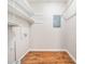 Walk-in pantry and laundry area features shelving for optimal storage and wood-look flooring at 1312 Rothes Rd, Cary, NC 27511