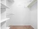 Bright walk-in closet with built-in shelving and clothing rods for ample storage at 1312 Rothes Rd, Cary, NC 27511