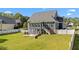 View of the back of a blue house and a large fenced-in green yard at 133 Aleah Ct, Clayton, NC 27520
