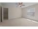 Neutral bedroom with carpet flooring, a ceiling fan, and a bright window at 133 Aleah Ct, Clayton, NC 27520